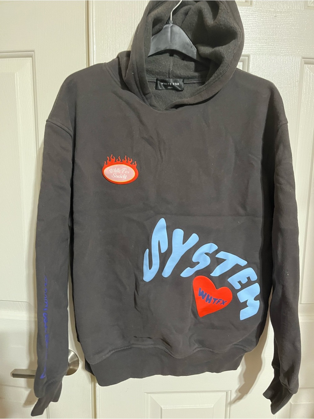 White Fox Boutique Black Hoodie with Blue SYSTEM Graphic and Red Accents
15-03